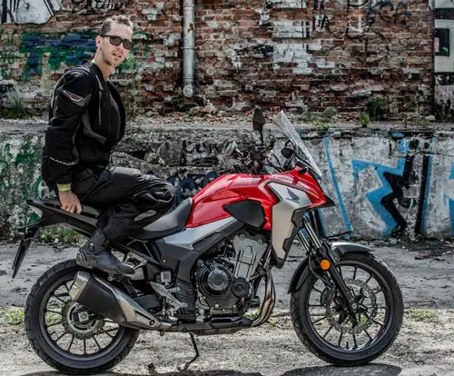 I am sitting in the back of a Honda CB500X